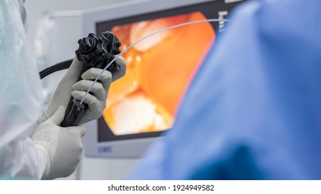 Close up photo of surgeon 's hands inside modern operating room in blue surgical gown suit. Doctor using endoscopic retrograde cholangio pancreatography in gall stone patient with abdominal pain.