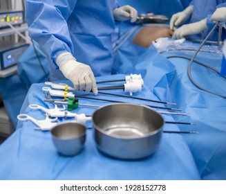 Close Up Photo Of Surgeon 's Hands Inside Modern Operating Room In Blue Surgical Gown Suit With Blur Background.Scrub Nurse Send Surgical Instrument To Surgeon In Key Hole Surgery.Medical Concept.