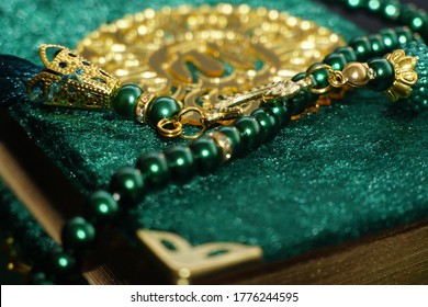 Close up Photo of Tasbih Muslim prayer beads in glossy Golden and green colour.