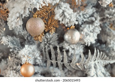 Close Up Photo Of Toy Balls In Silver And Gold On Trendy Luxury Snowy Christmas Tree