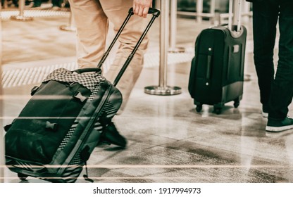 Close up photo a traveler man dragging his suitcase, manbag, pull bag through a airport (station)