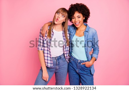 Close up photo two funky diversity she her ladies different race playful make careless facial expression hilarious wear casual jeans denim checkered shirt clothes outfit isolated pink background
