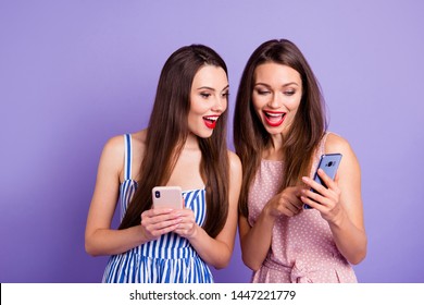 Close up photo two people beautiful she her models ladies telephone smart phone using showing novelty check instagram followers pictures wear colorful dresses isolated purple violet background