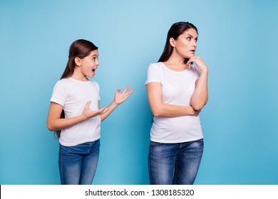 Close up photo two people brown haired mum disinterested ignoring small little daughter yelling ask chat speak tell talk mistakes sorry wear white t-shirts isolated bright blue background