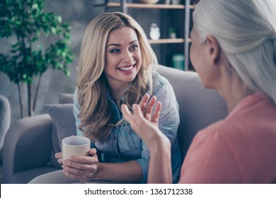 Close Up Photo Two People She Her Ladies Rumours Mom Granddaughter Child Granny Hot Beverage Tea Hands Conversation Tell Speak Say Funky Life Stories Sit Comfy Couch Divan Flat House Indoors