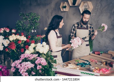 Close up photo two people she her lady watch attentive masterclass lesson him his he guy teach student take care check trimming stems prepare bunch fresh flowers owner small flower shop room indoors - Powered by Shutterstock