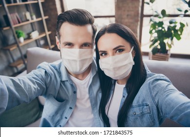 Close up photo of two people spouses make selfie blogging healthcare cov infection epidemic protection sit comfort couch wear medical mask in house indoors - Powered by Shutterstock