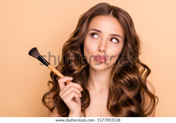 Close up photo of uncertain unsure girl\
hesitate hold blush blusher dont know apply powder rouge  to make\
visage ideal  isolated over pastel color\
background