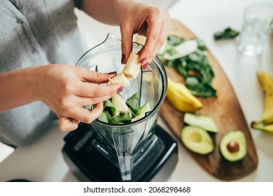 Close Up Photo of Woman Hands Making a Healthy Detox Drink in a Blender - a  Green Smoothie with Bananas, Green Spinach and Avocado. Healthy eating concept, ingredients for smoothies on the table. - Powered by Shutterstock