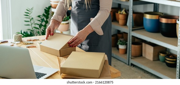 Close Up Photo Of Woman Hands Preparing Christmas Ornaments Of Clay For Delivery At Her Store