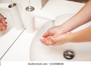 close up photo of woman washes her hands with soap and water. - Shutterstock ID 1110588038