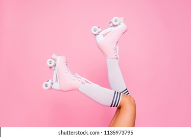 Close up photo of woman's body part. Legs wearing cute sweet with shoelaces four wheeled roller blades isolated tanned bright vivid background