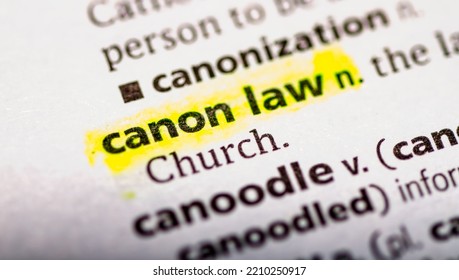 Close up photo of the words canon law in a dictionary book
