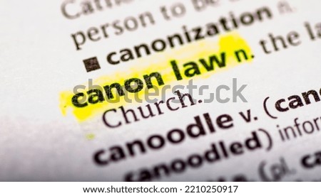 Close up photo of the words canon law in a dictionary book