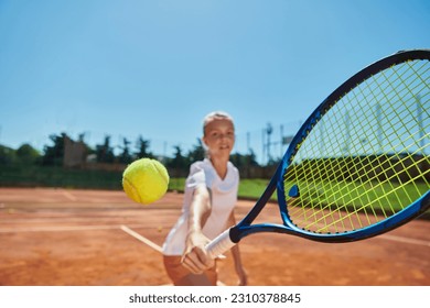 Close up photo of a young girl showing professional tennis skills in a competitive match on a sunny day, surrounded by the modern aesthetics of a tennis court. - Powered by Shutterstock