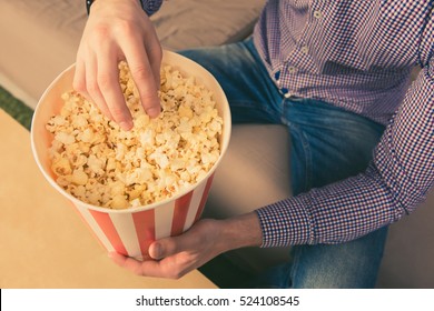 Close Up Photo Of Young Man Eating Popcorn At Home