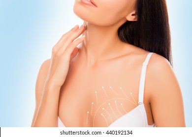 Close up photo of young sexy brunette touching her body