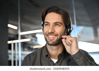 Close up photo of young smiling professional business man customer care representative service support call center agent telemarketing operator wearing headset working in call centre office. Portrait.