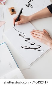 Close Up Photo Of Young Woman Hands Writing Cute Notes On Paper On Desk Isolated