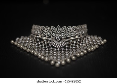 Close Up Photograph Of A Diamond Necklace Lined With Pearls In The End