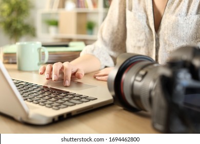 Close up of photographer woman hands connecting camera and laptop transfering files on a desk at home - Powered by Shutterstock