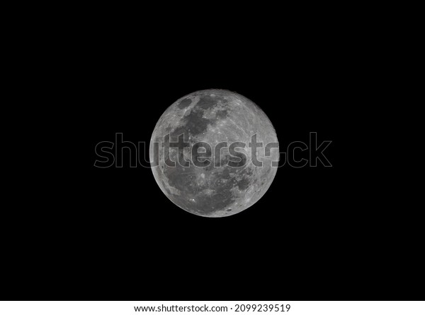 Close up photography of the moon with a telephoto\
lens, very sharp and detailed where you can see crates in a full\
moon phase.