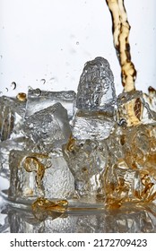 Close Up Photography Of Scotch Whiskey Pouring Onto Ice In A Glass