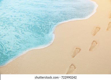 Close Up Photography - Tropical Blue Sea Water Coming On The White Beach Sand With Footprint