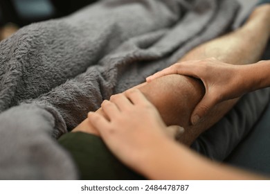 Close up physiotherapist treating injured knee of athlete man patient. Sport physical therapy and rehabilitation - Powered by Shutterstock