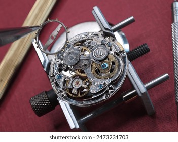 close up pic of watchmaker repairing vintage watch mechanism   - Powered by Shutterstock