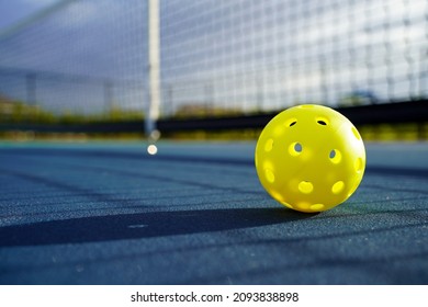 Close up of a pickleball on a pickleball court.                        