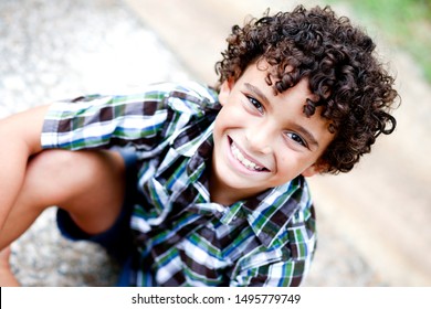 Close up picture of Beautiful Biracial African American Black Boy outdoor at nature park in the summer