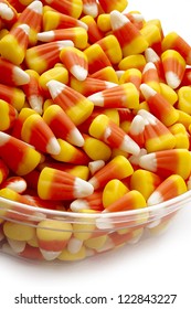 Close Up Picture Of Candy Corn In A Transparent Bowl.