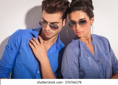 Close Up Picture Of A Casual Fashion Couple Looking Down, On Studio Background.