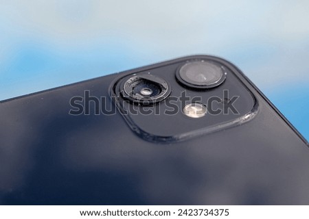 Close up picture of cell phone with one broken and one unbroken camera. Mobile phone with damaged camera needs repair. 