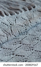 close up picture of gray design texture woven hand made knitting sweater, cardigan or shawl detail fabric copy space background 