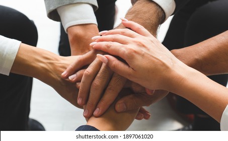 Close Up Picture Of Hands Of Multiethnic Business Team Touching In Circle For Sign Of Teamwork Trust And Collaboration. Together Concept