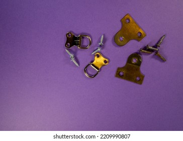 Close Up Of Picture Hangers Isolated On A Purple Background