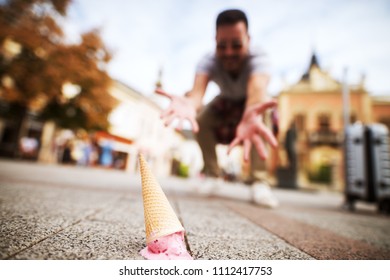 Close Up Picture Of An Icecream On Street Dropped By A Mourning Man.