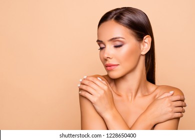 Close up picture of leisure lifestyle good-looking lovely charming pretty brown-haired lady hug her naked shoulders she close eyes isolated on pastel beige background with copy space for text