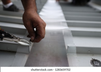 Close Up Picture Of Male Hand Repairing Using Cutter Cutting Wire Mesh Grid With Plier On The Roof, Construction, Work Site, Sydney, Australia