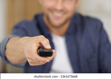 Close Up Picture Of Man Holding Remote Control