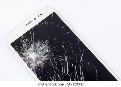 A close up picture an old white mobile phone with broken screen isolate on white background.
