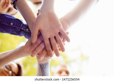 Close Up picture of people's hands put together. Symbol of teamwork and unity on achieving a certain goal - Shutterstock ID 1471236554
