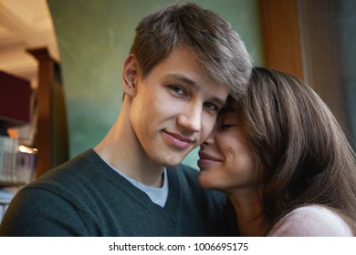 Close Up Picture Of Pretty Girl With Cute Smile And Stylish Clean Shaven Young Male Cuddling At Home, Having Happy Looks, Enjoying Each Other's Company. Love, Relationships And Happiness Concept