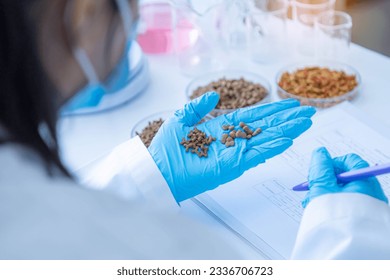 Close up picture of quality control personnel are inspecting the quality of canned pet food. Physical quality inspection. Quality control process of pet food industry.	 - Powered by Shutterstock