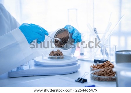 Close up picture of quality control personnel are inspecting the quality of canned pet food. Physical quality inspection. Quality control process of pet food industry.	
