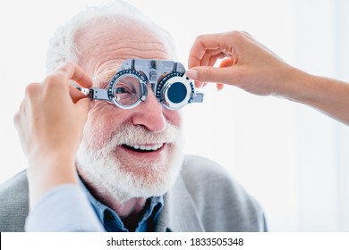 Close up picture of senior male patient with cheerful smile during ophthalmic vision check up - Powered by Shutterstock