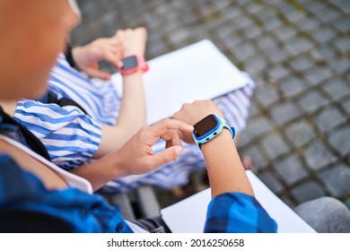 Close up picture of using kids smartwatch of boy and girl blue and pink color. - Powered by Shutterstock