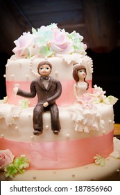 A Close Up Picture Of A Wedding Cake Topper